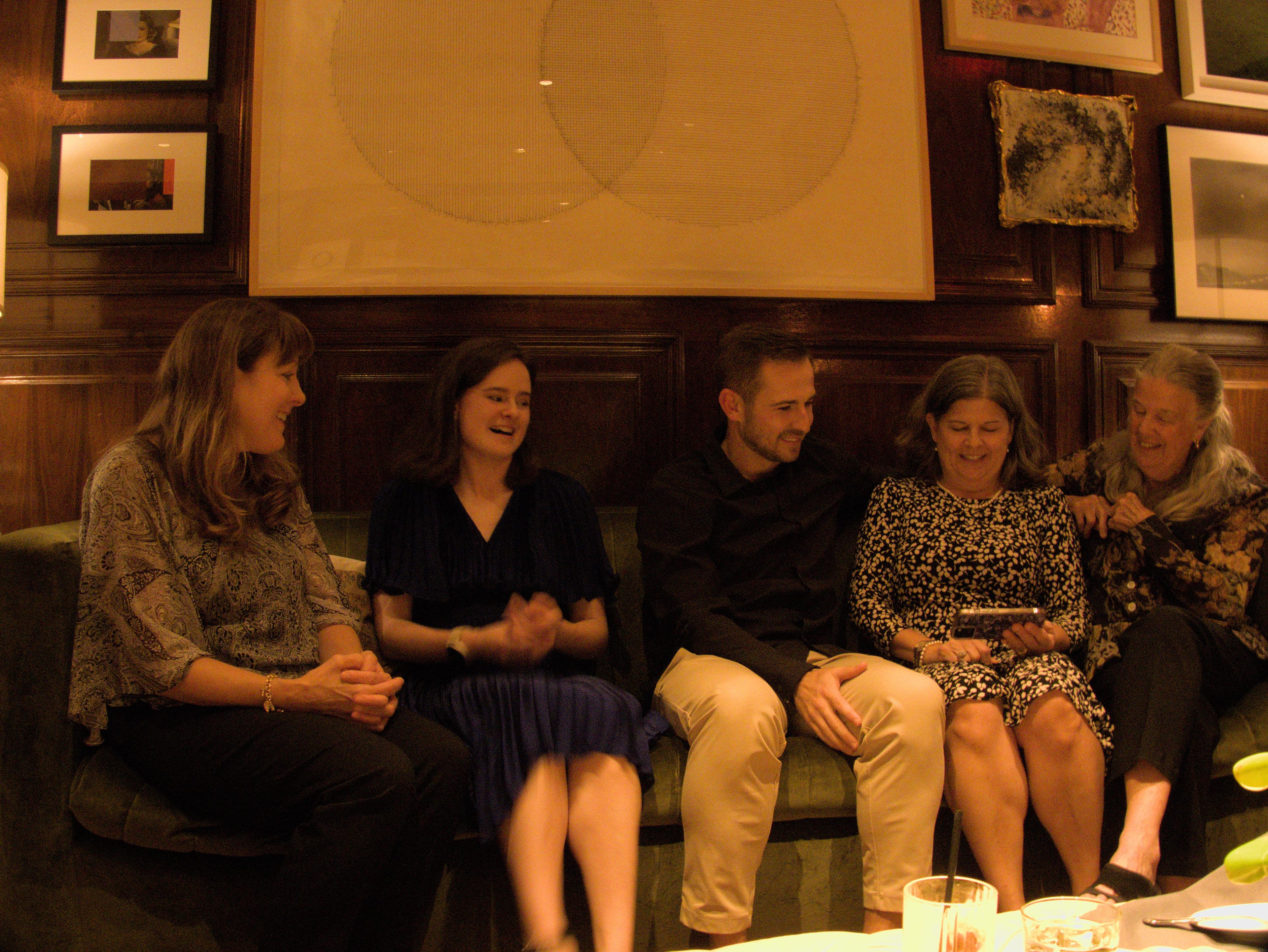 Group laughing together at evening gathering