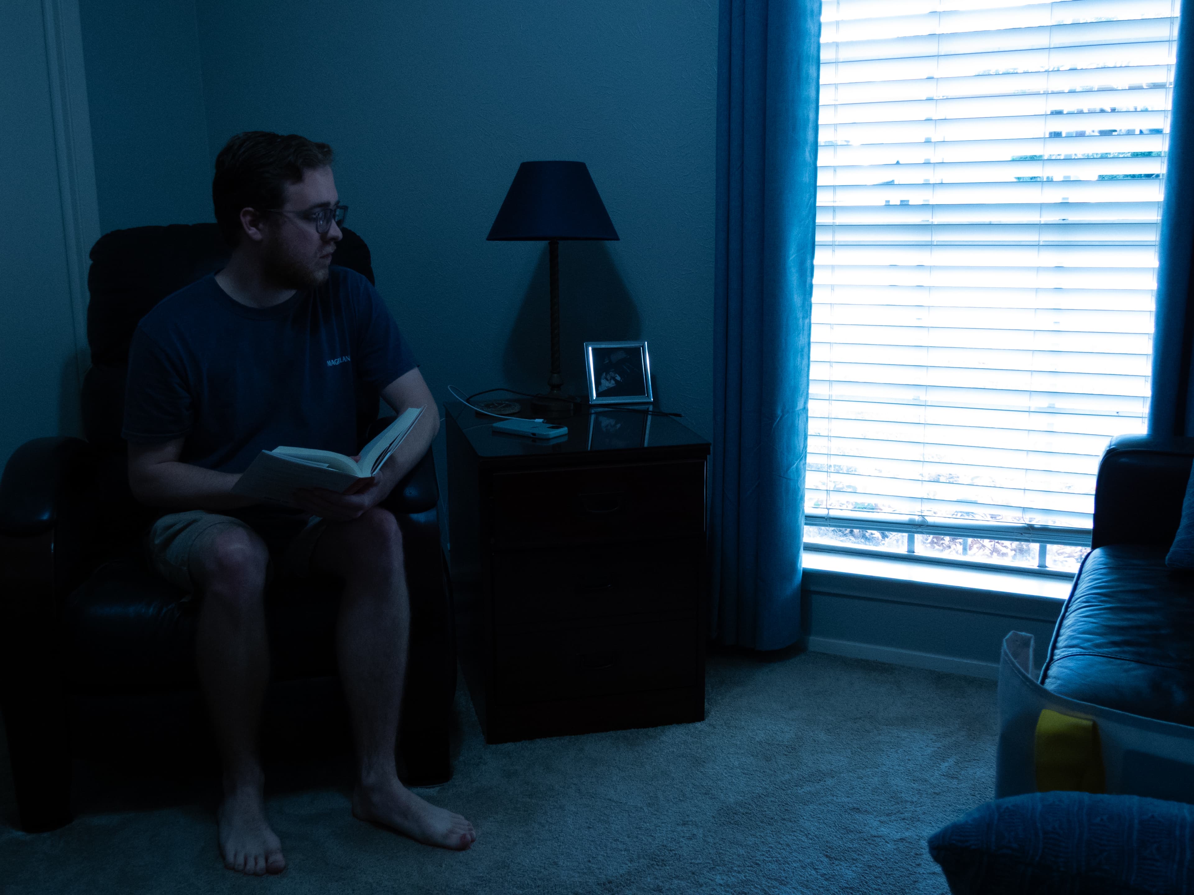 Reading by the window in the cool blue of evening